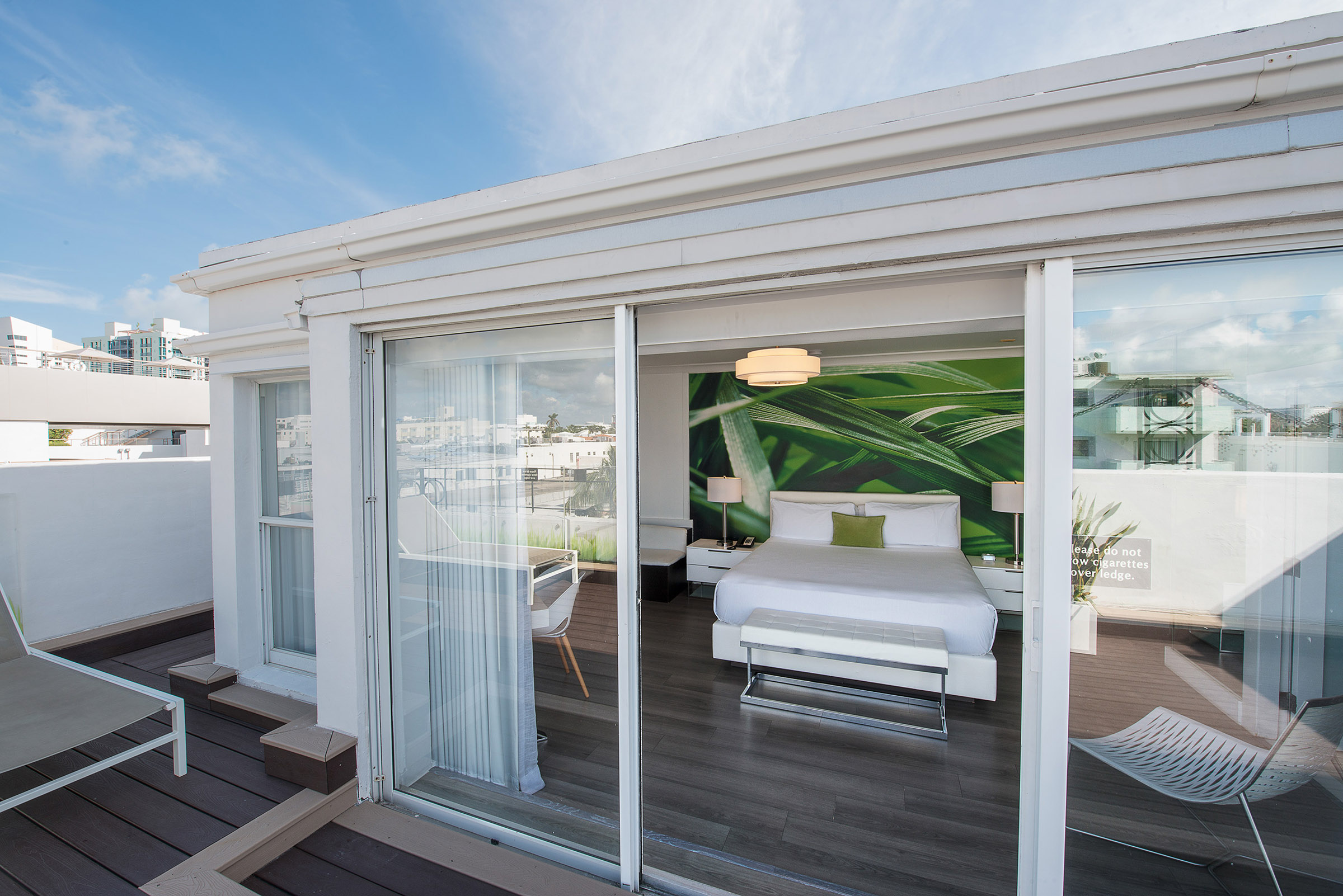 A modern suite with a balcony and city view